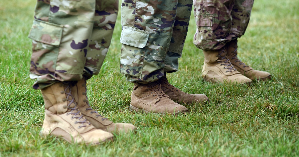 Military service members in uniform standing at attention - TruckWise veteran discount for Freedom Haulers
